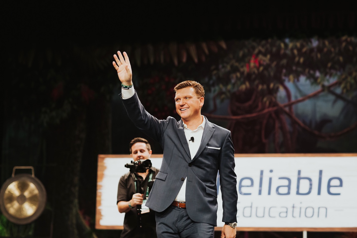 Joe Olejnik on stage waving to crowd